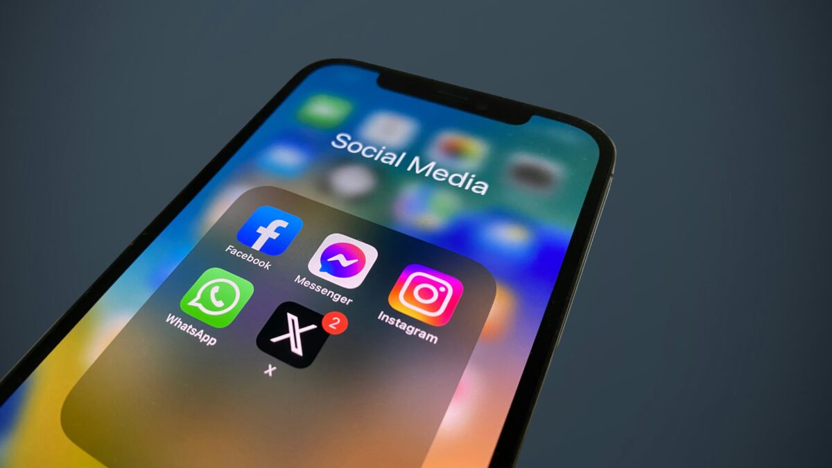 A mobile phone displaying social media apps' icons.