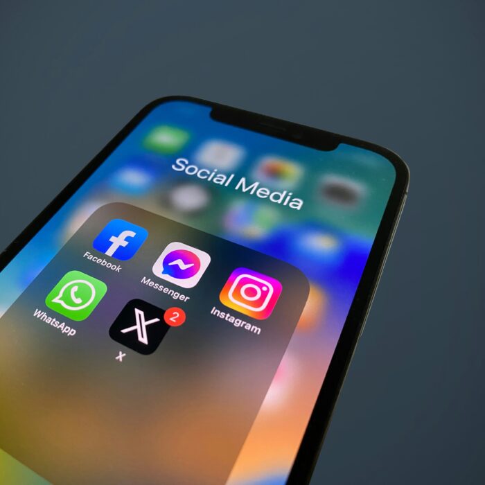 A mobile phone displaying social media apps' icons.