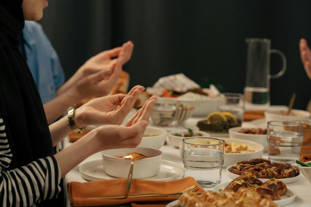 People praying on Iftaar table.