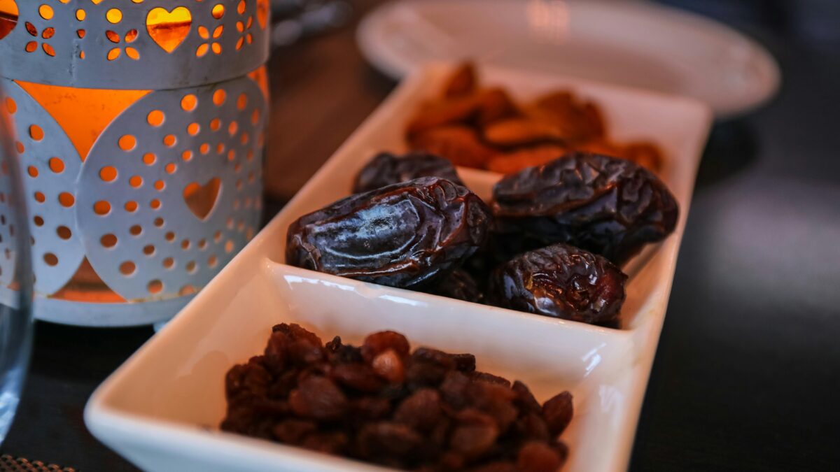 A closeup shot of dates and raisins in a dish for Ramadan.
