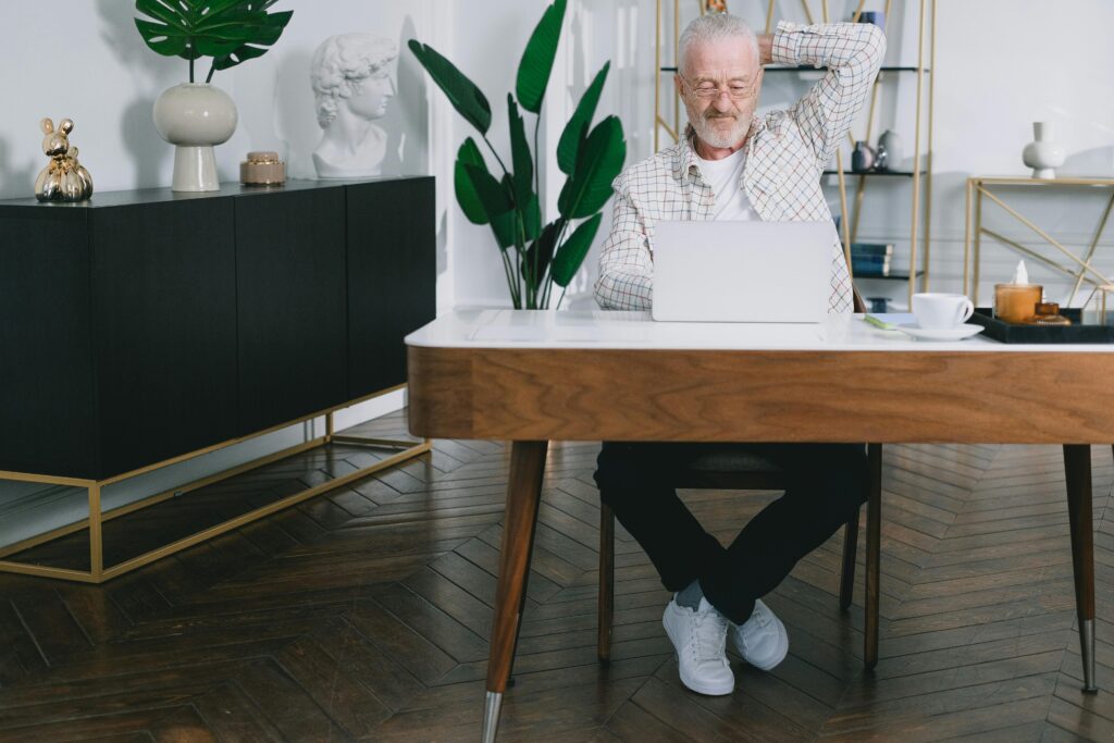 A business owner is busy using a laptop.