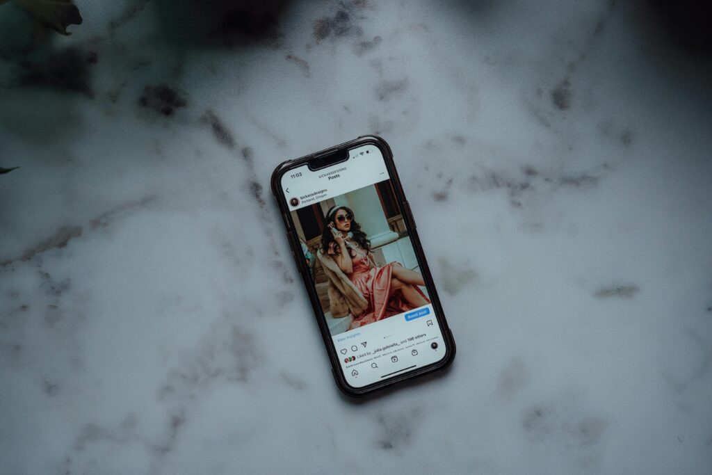 A phone displaying a brand's post on Instagram