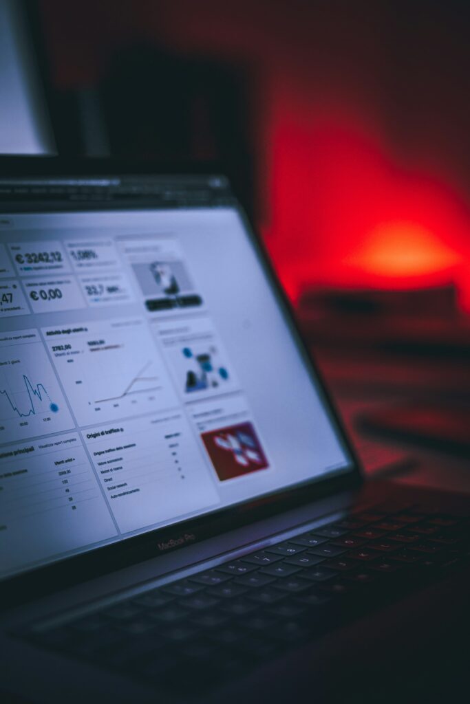 A MacBook shows analytics from Facebook Ads.
