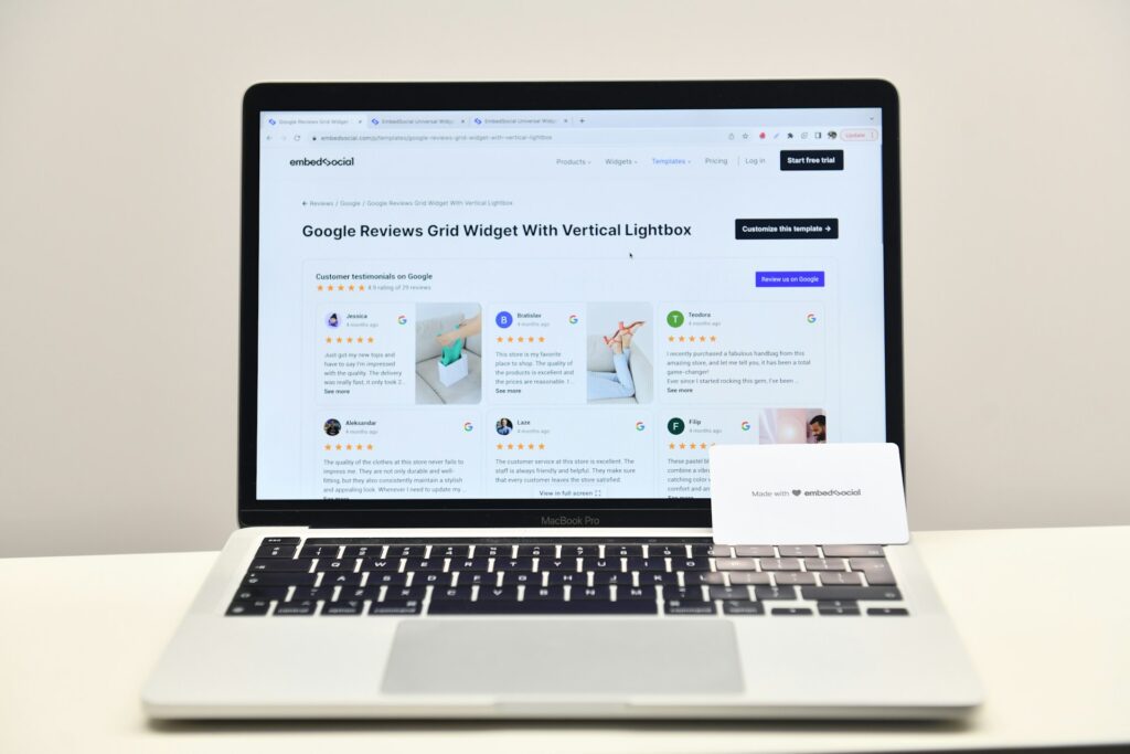 A laptop displays a webpage titled "Google Reviews Grid Widget With Vertical Lightbox," showcasing customer testimonials.